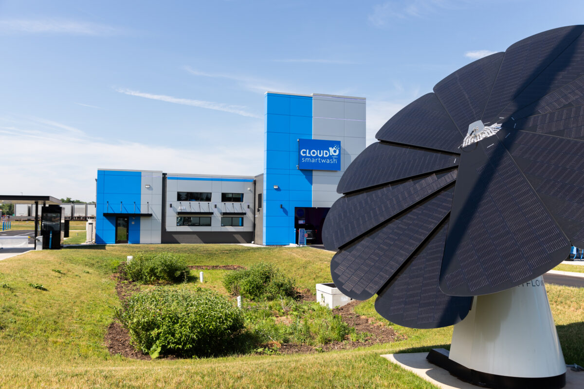 Cloud10 Smartwash behind a large, black solar panel structure