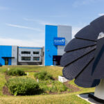 Cloud10 Smartwash behind a large, black solar panel structure