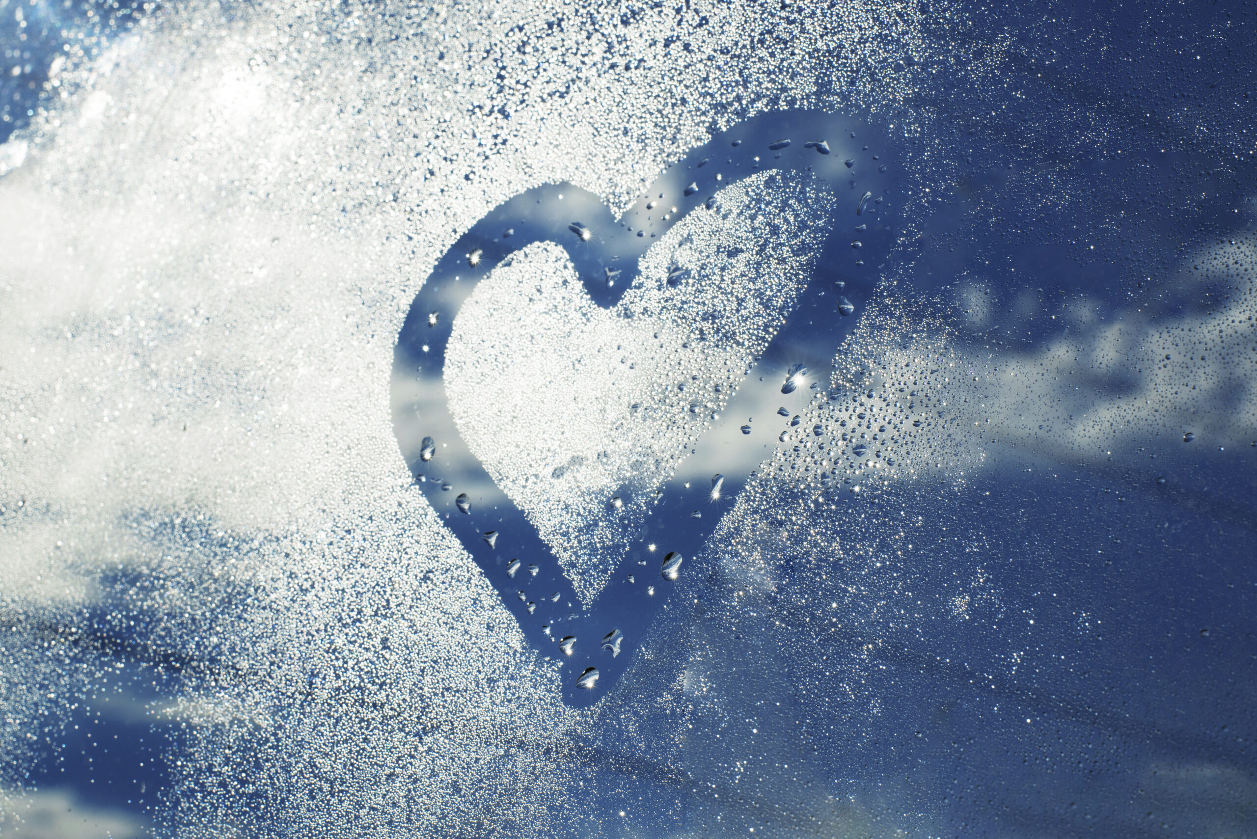 Heart drawn in humidity on a car window